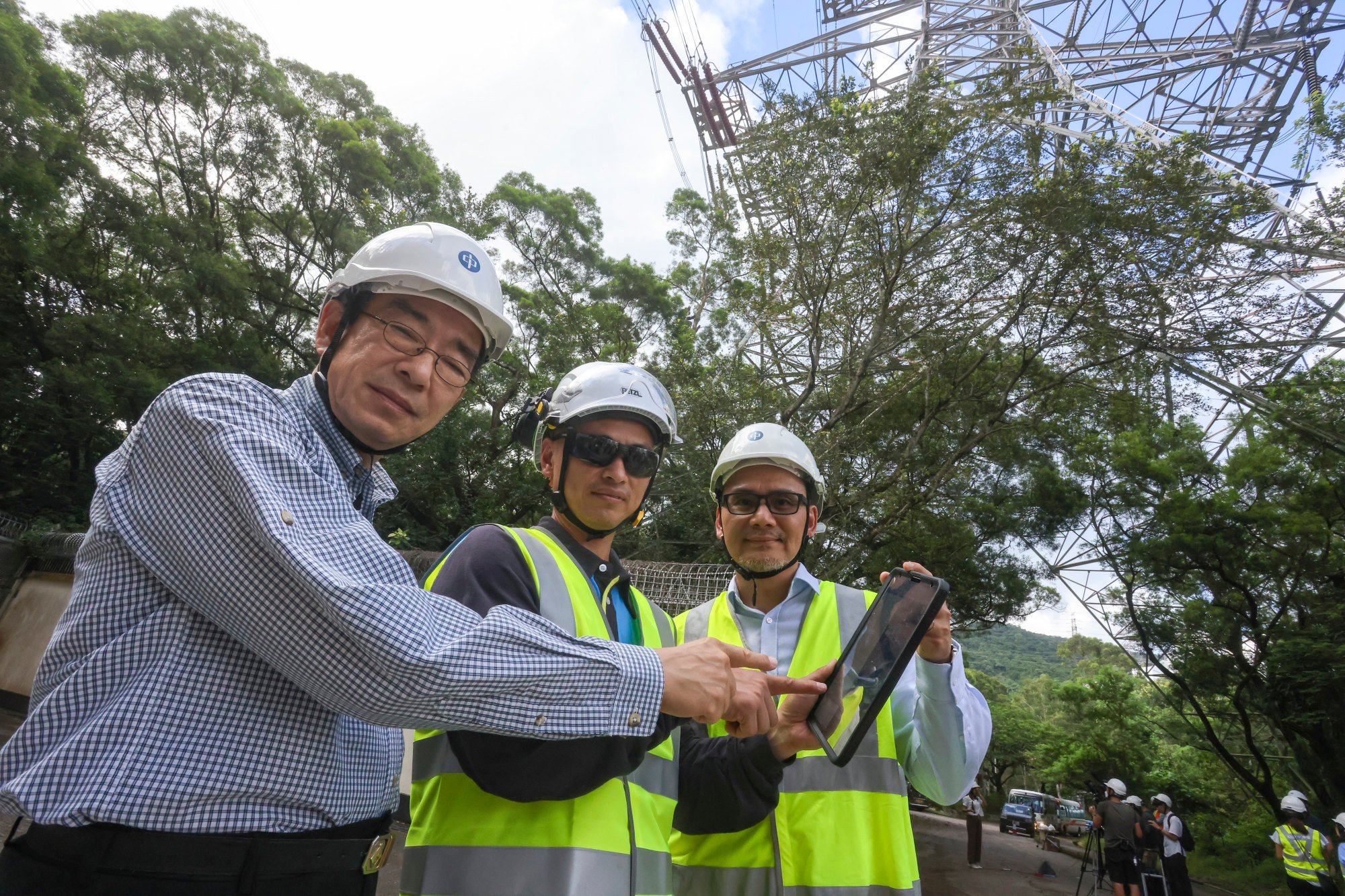 (From left) Education University research chair Professor Jim Chi-yung, CLP Power north region director Michael Lau and Liu Wai-lung, a senior technical supervisor, try out the new system. Photo: Jonathan Wong