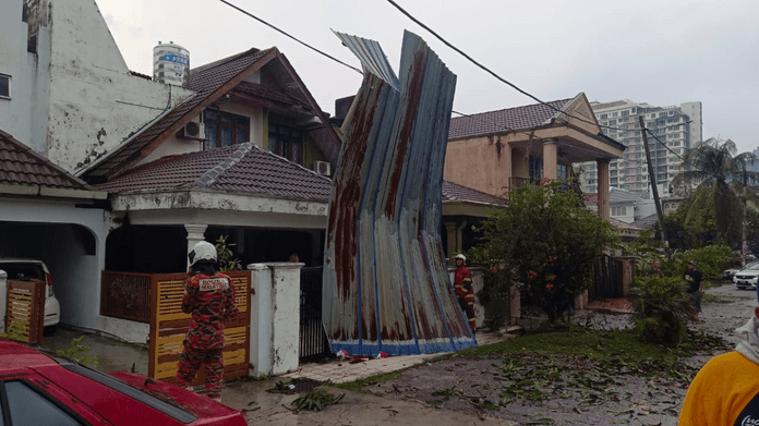 Metal roof piece flies off, ends up blocking front of house