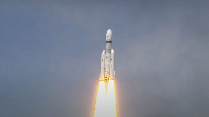 a white lvm3 rocket climbs into a blue sky